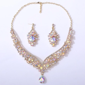 Macro detail of bridal jewelry set with pear-cut iridescent crystals and gold finish