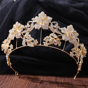 Macro shot of gold floral bridal tiara with sparkling crystal rhinestones and leaf patterns