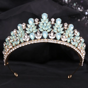 Macro detail of alloy bridal crown with light blue crystal teardrops and gold leaves