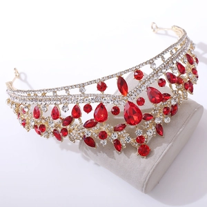 Detailed macro of gold bridal crown with red teardrop crystals and brilliant rhinestones