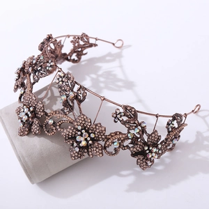 Close-up of vintage baroque purple floral tiara with bronze petals and sparkling rhinestones