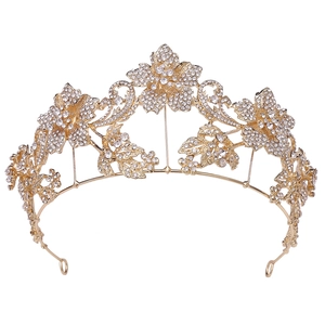 Detail view of gold floral bridal tiara featuring shimmering rhinestones and leaf accents