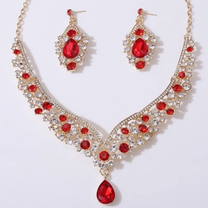 Detailed view of bridal jewelry set with red teardrop crystals and sparkling rhinestones