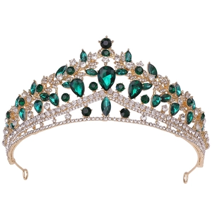 Luxury gold bridal crown with emerald green teardrop stones and sparkling white rhinestones