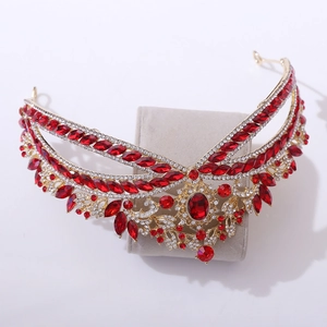 Detailed close-up of luxury gold bridal crown with red rhinestones and white zirconias