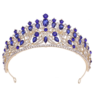 Close-up of golden bridal tiara featuring royal blue gemstones and sparkling crystals