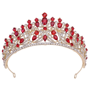 Detail of bridal crown featuring red teardrop crystals and gold floral metalwork