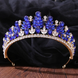 Detailed macro view of an elegant gold alloy bridal crown with blue rhinestones