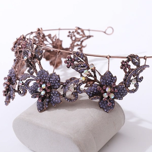 Macro shot of vintage bronze bridal tiara with purple rhinestones and crystal flowers