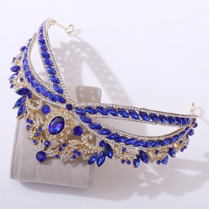 Detailed side view of luxury bridal crown with royal blue gemstones and crystals