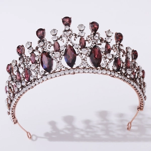 Detail of baroque vintage crown with deep purple crystals and small white rhinestones