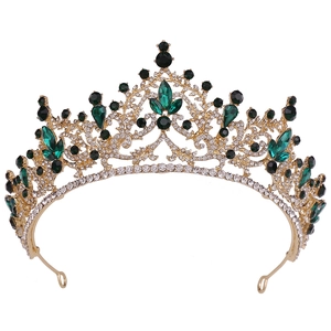 Détail d'un diadème baroque doré avec des pierres vert émeraude et cristaux noirs