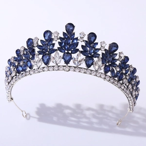 Close-up of silver tiara with navy blue and clear crystal leaf patterns for brides