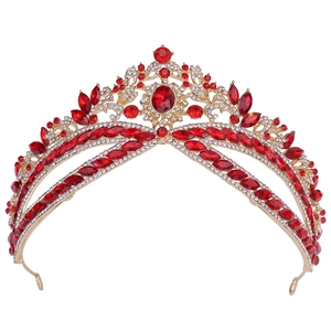 Close-up of golden bridal tiara with sparkling red rhinestones in a sunburst design