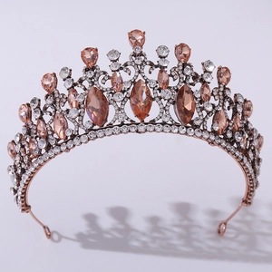 Macro shot of rose gold baroque bridal crown with champagne and pink rhinestones