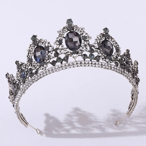 Macro detail of Baroque bridal tiara featuring grey gemstones and intricate silver carving