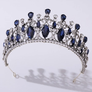 Detailed macro view of silver tiara with deep blue rhinestones and crystal accents
