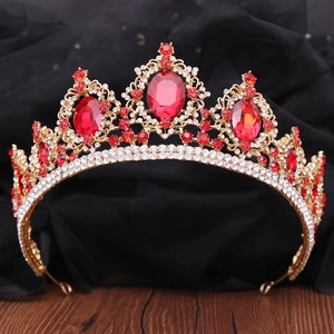 Baroque gold bridal crown with red rhinestones and crystal accents on black satin