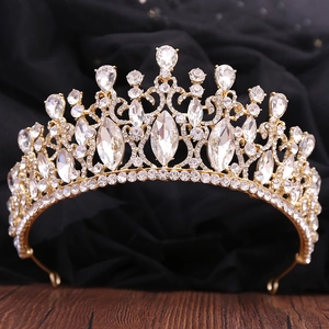 Close-up of golden baroque bridal crown with clear crystals and intricate metalwork