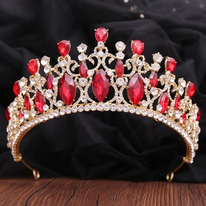 Detailed macro view of baroque bridal crown with red crystals and gold metal frame