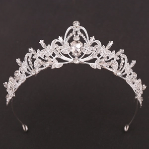 Exquisite bridal crown with silver leaf design and heart-shaped rhinestone centerpiece