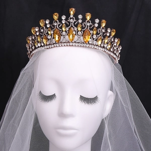 Baroque vintage bridal crown with amber crystals and white zircons on a black background
