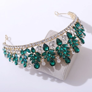 Detailed macro view of the golden leaf crown featuring green crystals and clear rhinestones