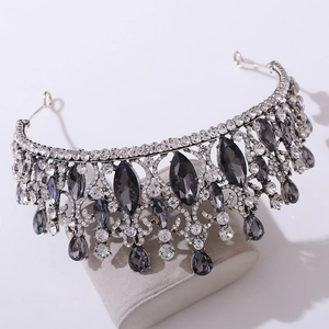 Detail of baroque bridal crown with grey gemstones and clear crystals on velvet stand