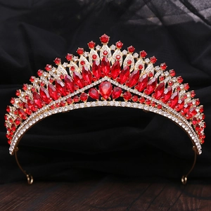 Macro detail of luxury bridal crown with red teardrop rhinestones and gold alloy frame