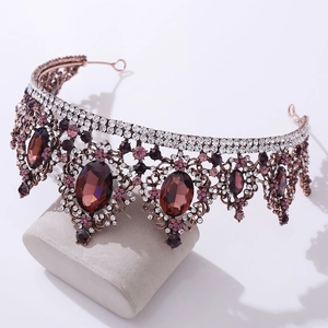 Macro view of rose gold baroque bridal crown with purple crystals and rhinestones