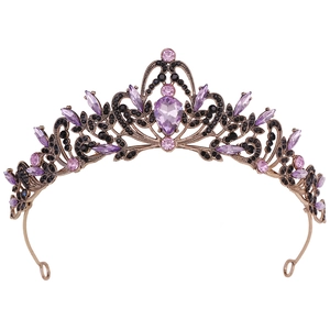 Vintage bronze bridal tiara with purple heart stone and black rhinestones on white background