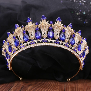 Detailed view of bridal crown with blue gemstones and diamonds on vintage wood surface