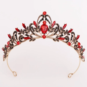 Close-up of golden crown with red teardrop rhinestones and black crystal accents