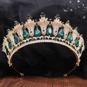 Close-up of Baroque crown with emerald teardrop stones and white zircons on gold alloy