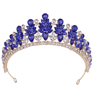 Close-up of alloy bridal tiara featuring navy blue leaf rhinestones and gold plating