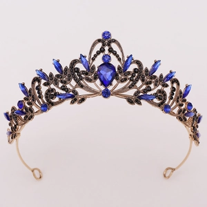 Detail of baroque crown with navy blue teardrop gemstones and antique gold metal
