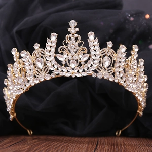 Close-up of golden baroque bridal crown featuring crystal wheat ears and teardrop stones