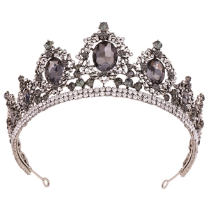 Close-up of Baroque vintage crown with silver metal, white rhinestones and grey gems