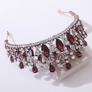 Macro view of vintage baroque tiara with deep purple crystals and rose gold metal plating