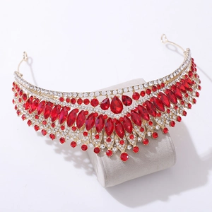 Macro view showing the intricate red and white crystal setting on the gold bridal tiara