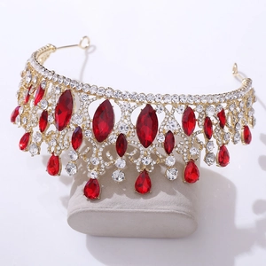 Detail of baroque bridal tiara with golden filigree and large red water-drop gemstones