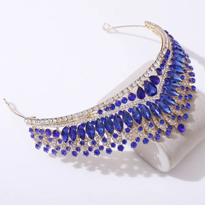Detail of luxury bridal crown with deep blue crystals and rhinestones in gold setting