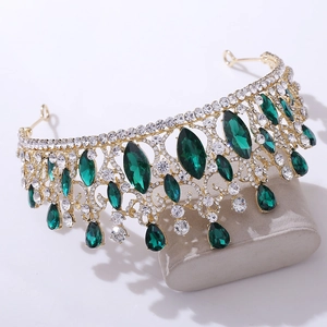 Detail of baroque bridal crown featuring emerald green crystals and sparkling rhinestones