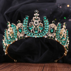 Detailed macro shot of deep green crystals and golden alloy on baroque bridal crown