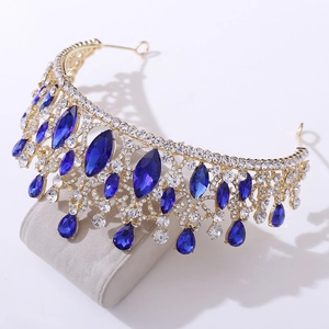Detail of baroque gold crown with deep blue marquise crystals and round rhinestones
