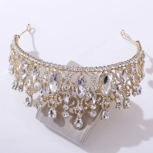 Detailed close-up of a golden baroque crown with marquise and teardrop crystals