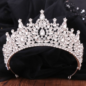 Detailed close-up of Baroque crystal bridal crown with sparkling rhinestones on dark base