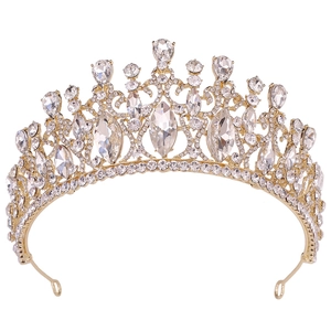 Close-up of golden Baroque bridal crown with shimmering crystals and intricate metalwork