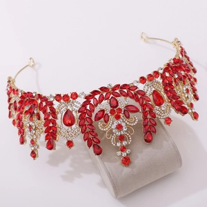 Detailed close-up of Baroque crown with red crystals and leaf-shaped gold settings
