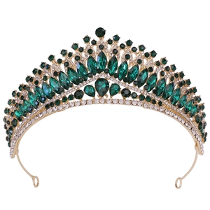 Luxurious gold bridal crown with deep green pear-shaped crystals and sparkling rhinestones